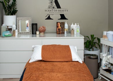 Relaxing treatment room at A Scent of Beauty, Woodcroft, South Australia, AU with cozy table and decor.