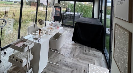 Chic nail studio setup at Polished By Poppy, Unsworth, England, GB, with modern decor and lush garden views.