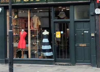 Front view of Jenelle Thompson hair @ Giovanni’s, boutique exterior in London, England, GB showcasing stylish dresses.