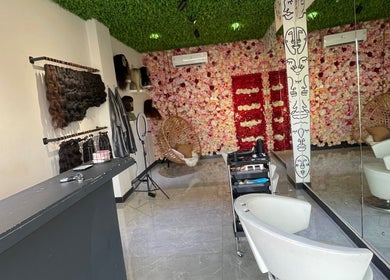 Flarehairgh salon interior in Madina, Greater Accra Region, GH, with floral walls and modern hair styling chairs.