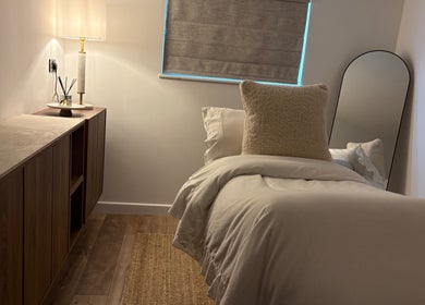 Elegant beauty room at Netherfield Retreat, Castleford, England with soft lighting and plush bedding.