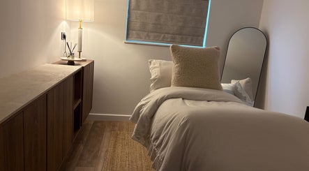 Elegant beauty room at Netherfield Retreat, Castleford, England with soft lighting and plush bedding.