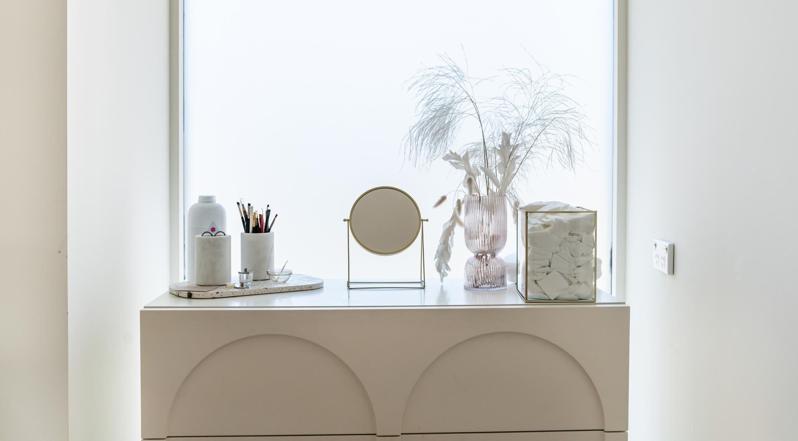 Elegant vanity setup at Laque Collective Ladies Salon, Dubai, Dubai, AE with mirror, brushes, and decor.