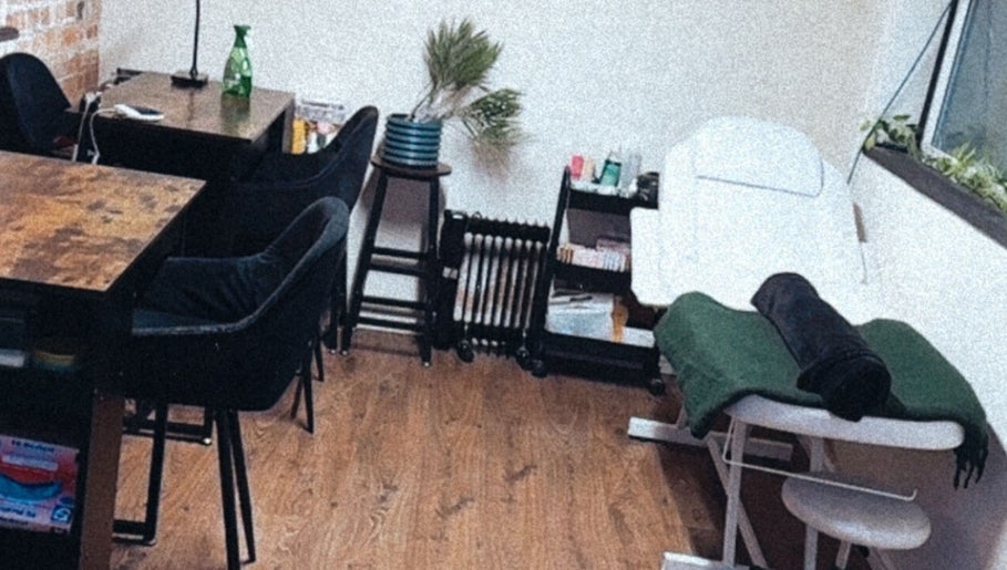 Interior of Lubello’s in Scunthorpe, England, GB, featuring a cozy spa treatment area with a massage table and seating.
