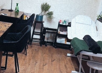Interior of Lubello’s in Scunthorpe, England, GB, featuring a cozy spa treatment area with a massage table and seating.