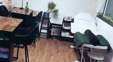 Interior of Lubello’s in Scunthorpe, England, GB, featuring a cozy spa treatment area with a massage table and seating.