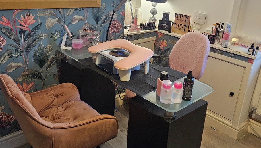 Cozy nail station at Kawaii Nails, Neath, Wales, GB with floral wallpaper and manicure tools.