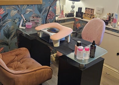 Cozy nail station at Kawaii Nails, Neath, Wales, GB with floral wallpaper and manicure tools.