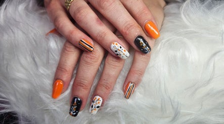 Autumn-themed nail art at Kawaii Nails in Neath, Wales, GB with orange, black, and white designs.