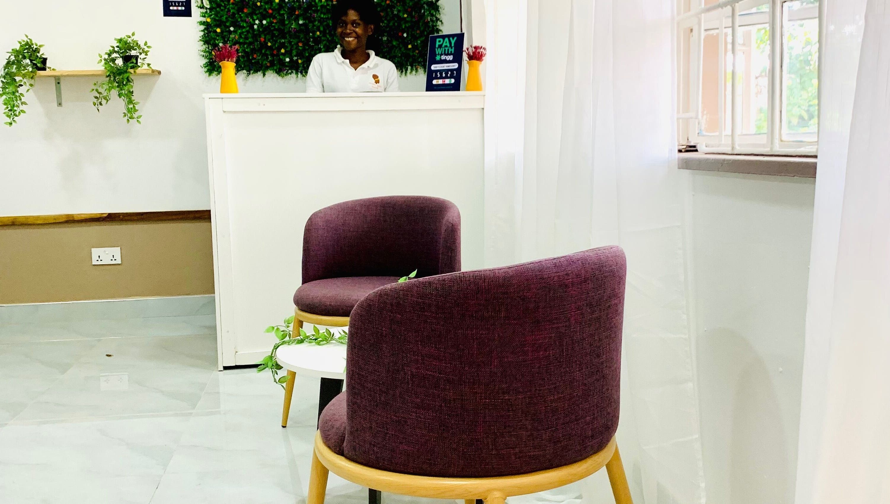 Inviting reception area at Crown Your Mane, Lusaka, Lusaka Province, ZM, with modern seating and vibrant decor.