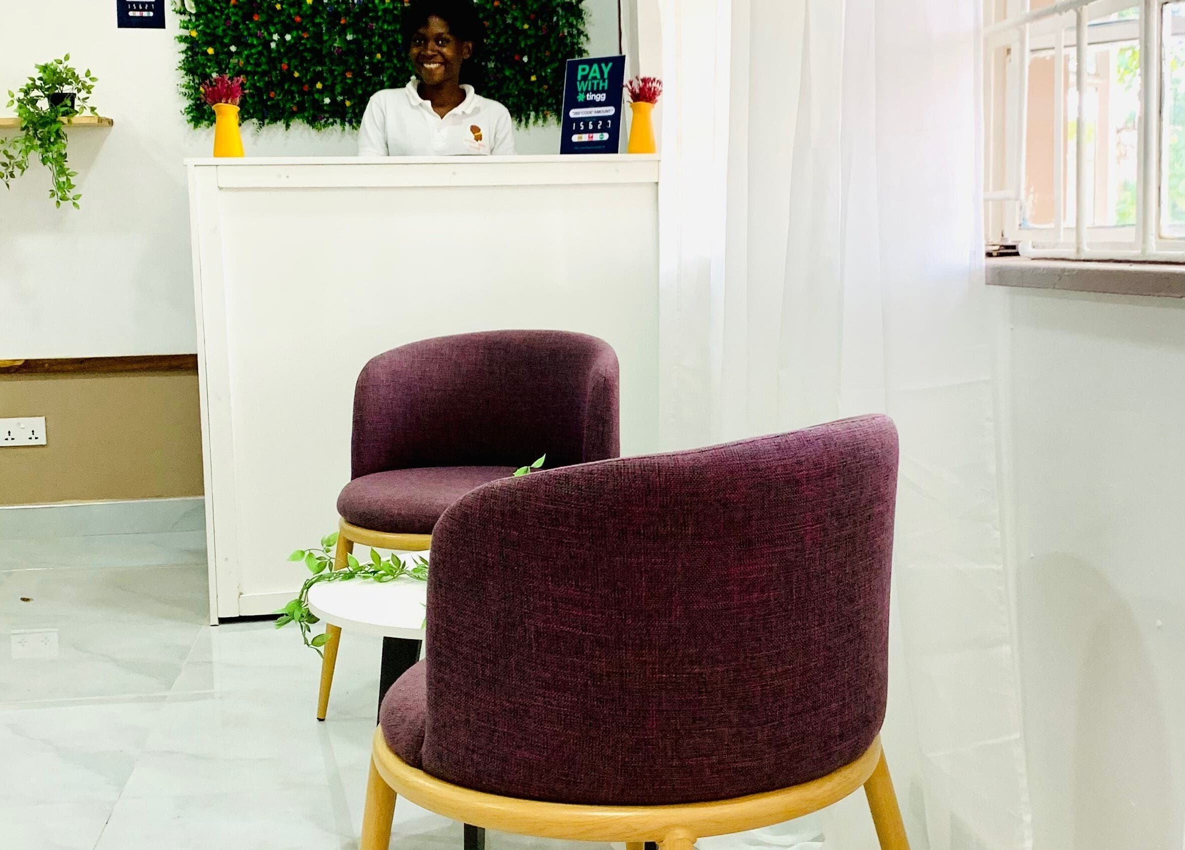 Inviting reception area at Crown Your Mane, Lusaka, Lusaka Province, ZM, with modern seating and vibrant decor.