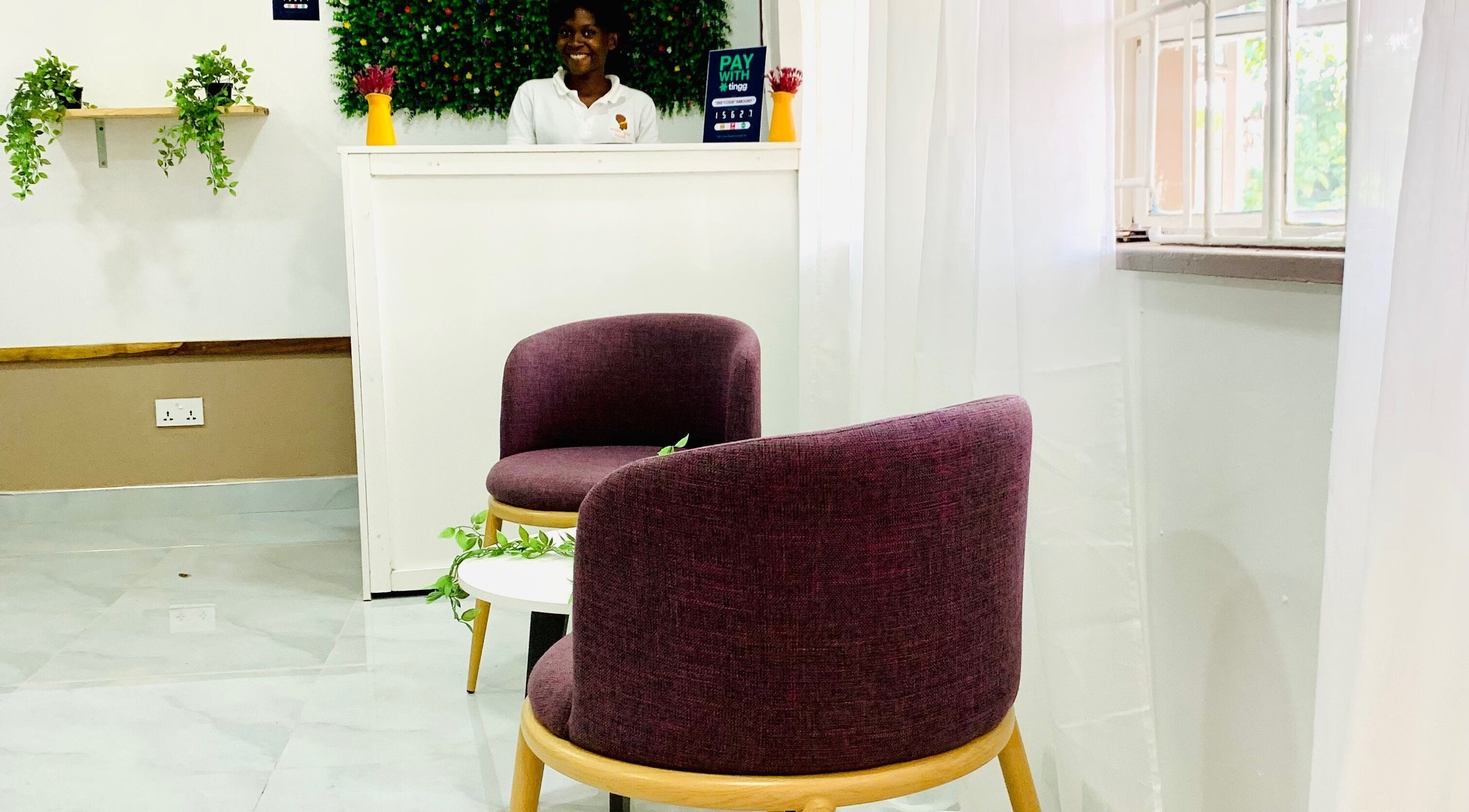 Inviting reception area at Crown Your Mane, Lusaka, Lusaka Province, ZM, with modern seating and vibrant decor.