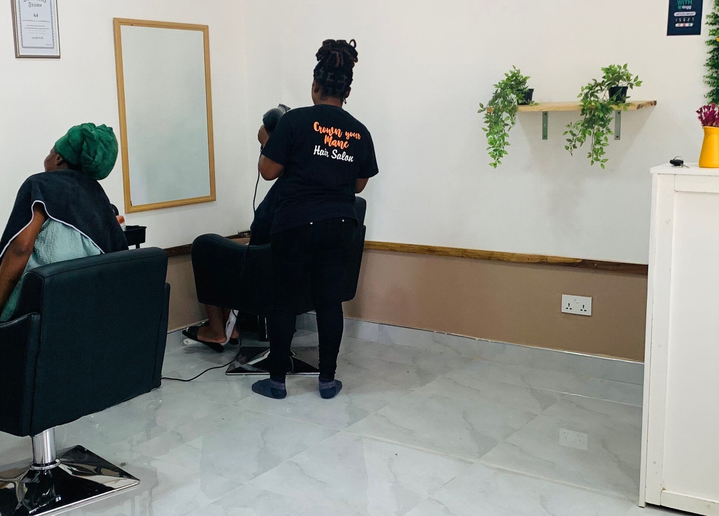 Client receiving a hair treatment at Crown Your Mane, Lusaka, Lusaka Province, ZM.