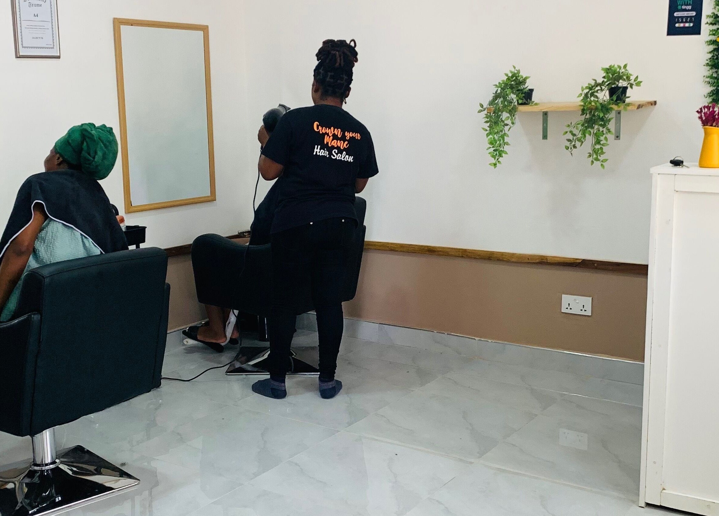 Client receiving a hair treatment at Crown Your Mane, Lusaka, Lusaka Province, ZM.