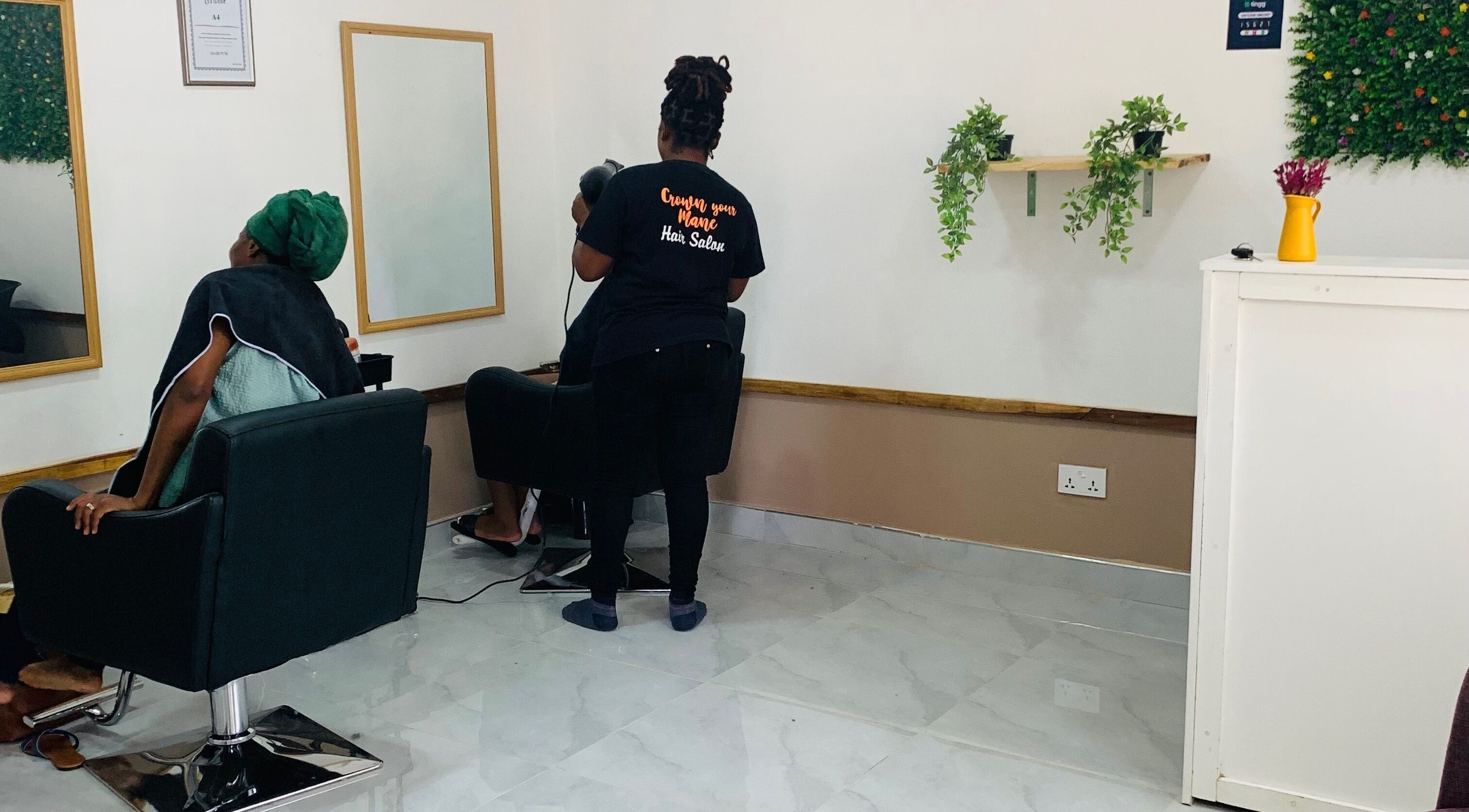 Client receiving a hair treatment at Crown Your Mane, Lusaka, Lusaka Province, ZM.