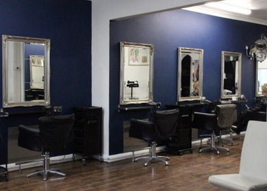 Chic salon interior at The Salon Langley Park in Langley Park, England, GB with stylish chairs and mirrors.