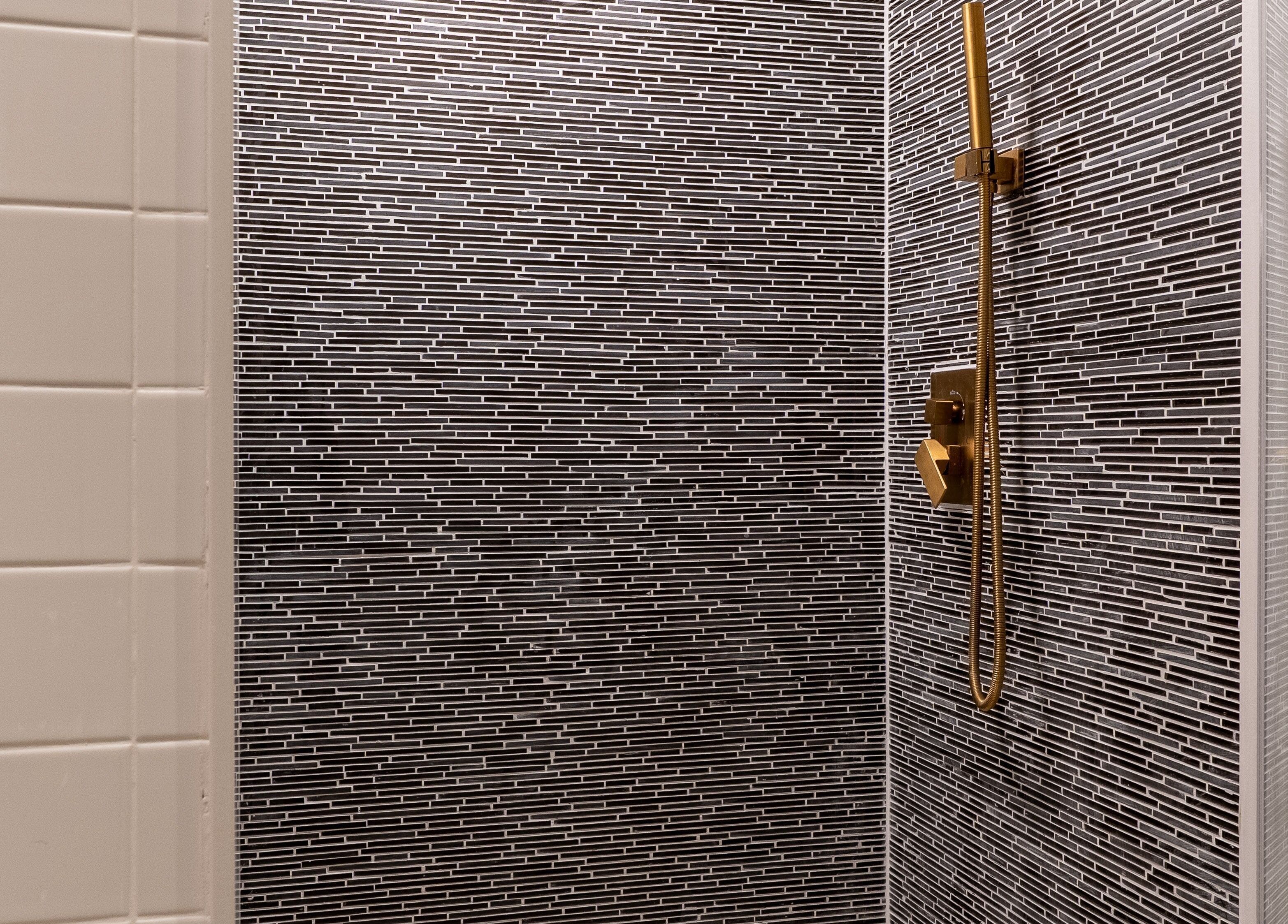 Modern black tile shower at The Waxing Strip (Aurora), located in Aurora, Ontario, CA.