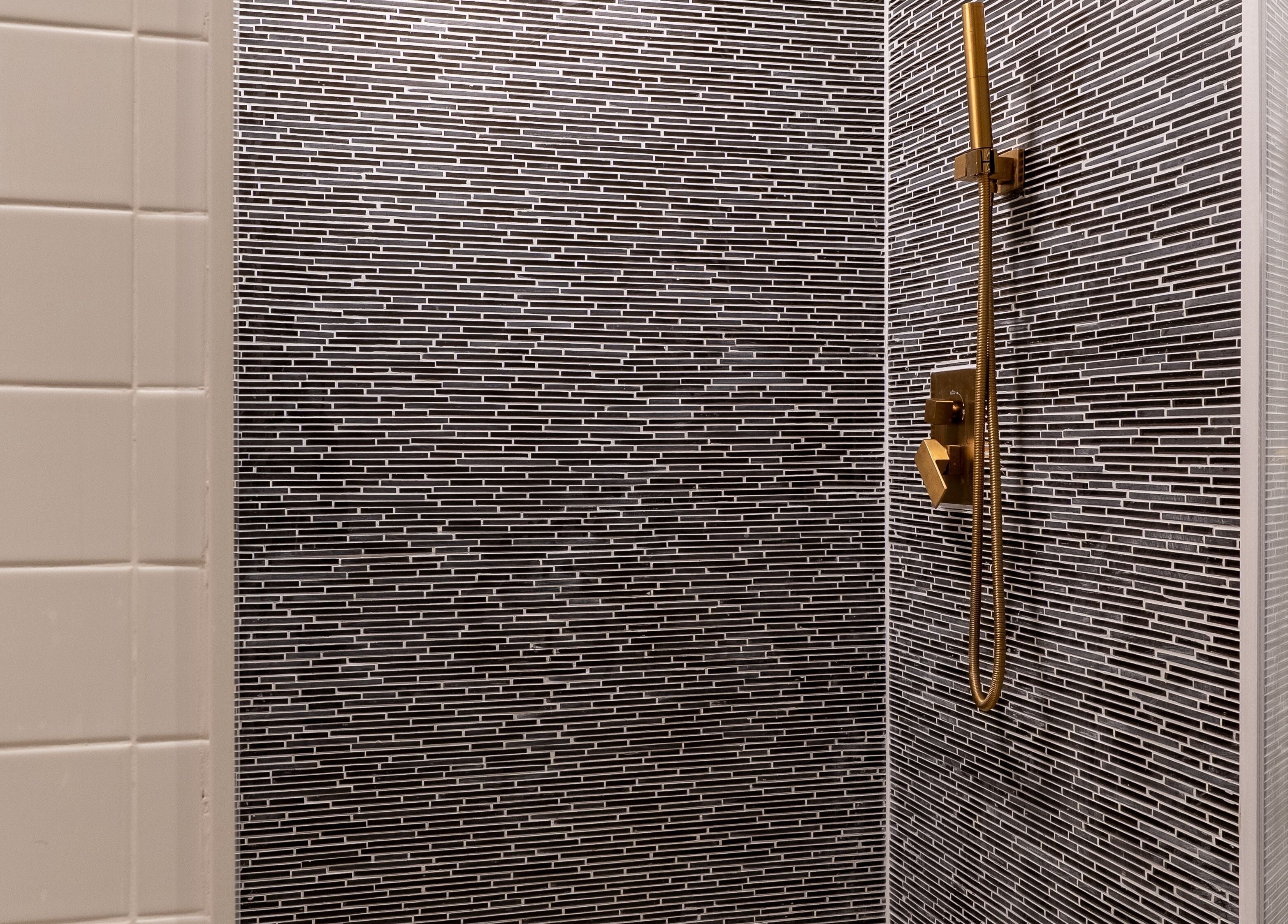 Modern black tile shower at The Waxing Strip (Aurora), located in Aurora, Ontario, CA.