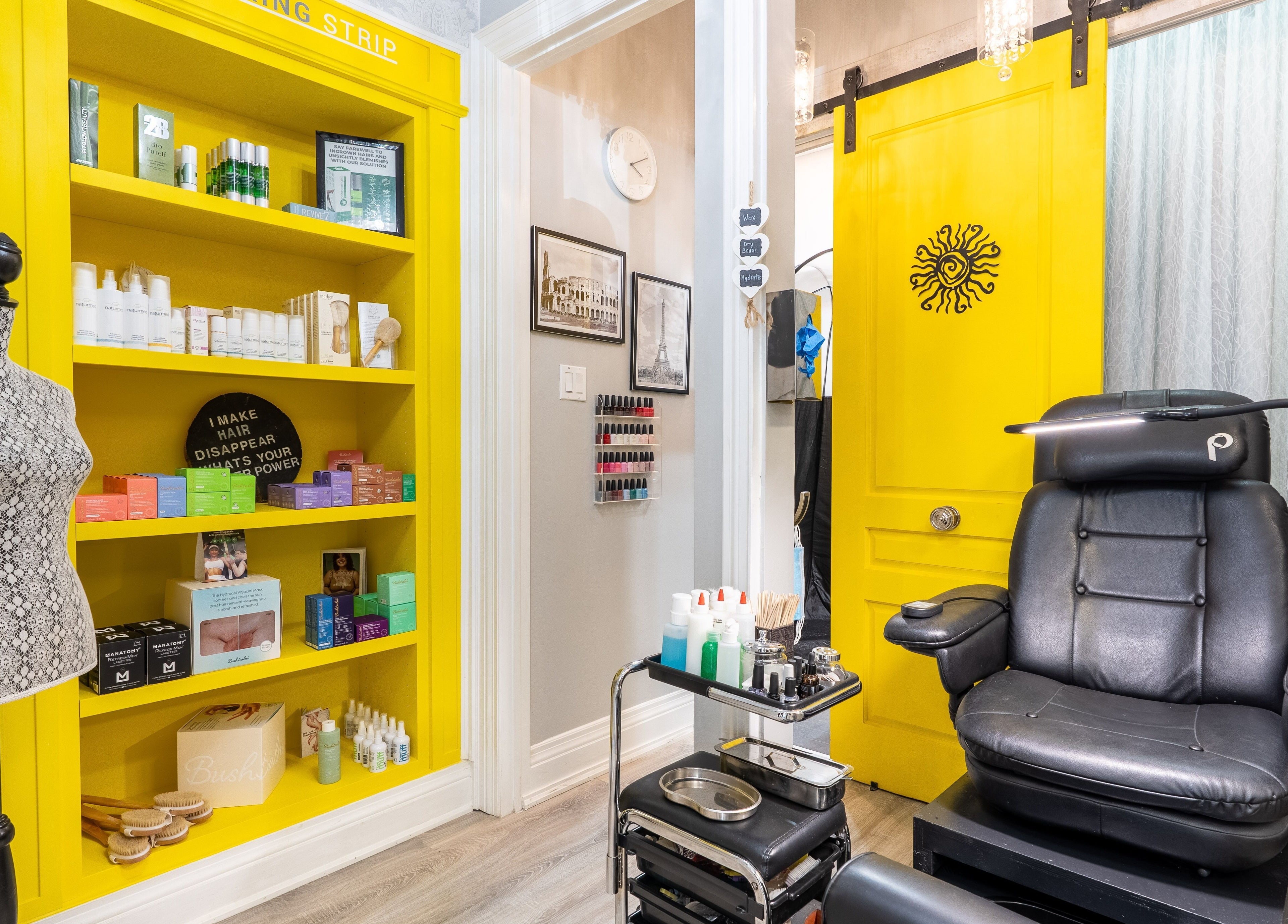 Modern salon chair and vibrant yellow shelves at The Waxing Strip (Aurora), Aurora, Ontario, CA.