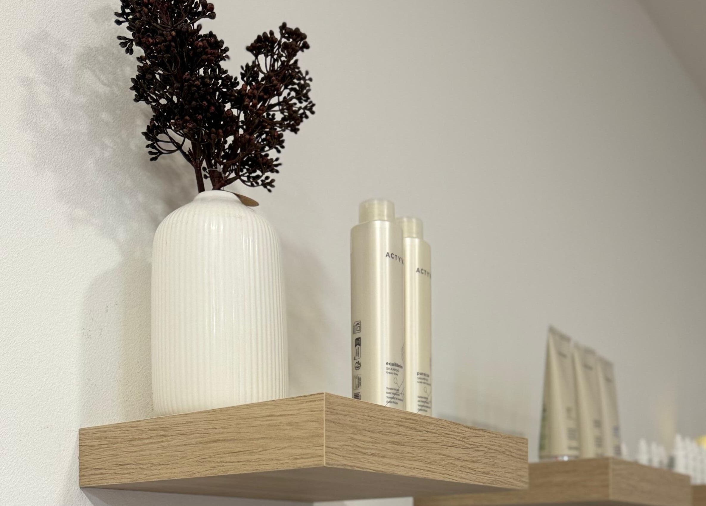 Elegantna dekoracija polica u NOELLI SPA, Zagreb, Grad Zagreb, HR, s bocama i biljkama.