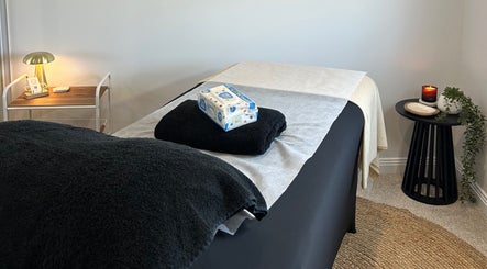 Serene therapy room at Beauty By Iona, Jindalee, Western Australia, AU, showcasing a cozy massage table setup.