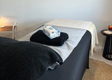 Cozy spa room at Beauty By Iona, Jindalee, Western Australia, AU, with massage bed and relaxing decor.