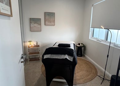 Calm treatment room at Beauty By Iona in Jindalee, Western Australia, AU, featuring a massage table and soft lighting.