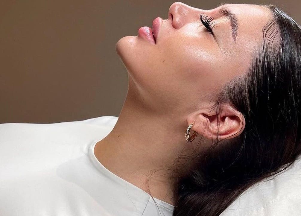 A serene woman enjoying a beauty treatment at Fill&bo, Bournemouth, England, GB, exuding relaxation and bliss.