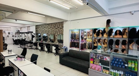 Modern interior of LAVISH LOOKS HAIR STUDIO in Cape Town, ZA, featuring styling chairs and hair products.