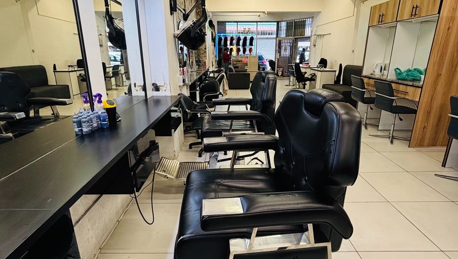 Interior of LAVISH LOOKS HAIR STUDIO in Cape Town, Western Cape, ZA featuring stylish black salon chairs.