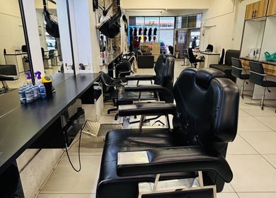 Interior of LAVISH LOOKS HAIR STUDIO in Cape Town, Western Cape, ZA featuring stylish black salon chairs.