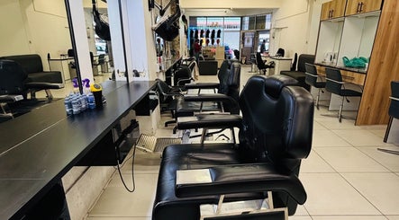 Interior of LAVISH LOOKS HAIR STUDIO in Cape Town, Western Cape, ZA featuring stylish black salon chairs.