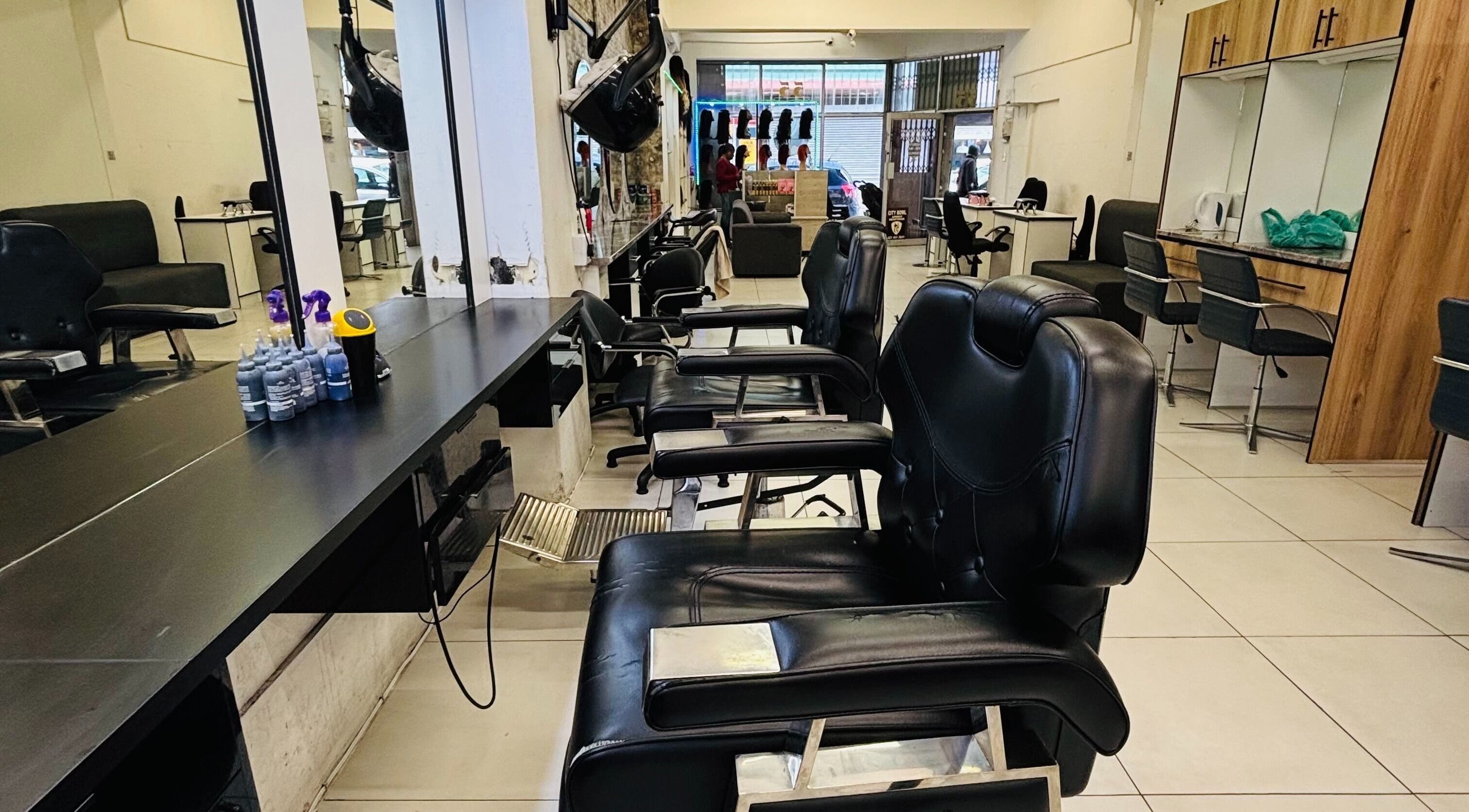 Interior of LAVISH LOOKS HAIR STUDIO in Cape Town, Western Cape, ZA featuring stylish black salon chairs.