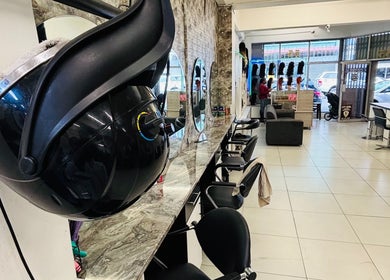 Interior view of LAVISH LOOKS HAIR STUDIO in Cape Town, Western Cape, ZA with salon chairs and mirrors.