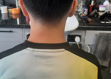 Back view of a sleek haircut at RA FADE BARBERS, London, England, GB, showcasing professional fade style.