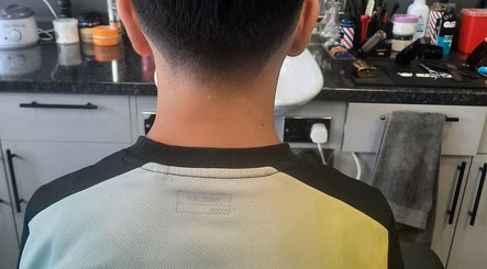 Back view of a sleek haircut at RA FADE BARBERS, London, England, GB, showcasing professional fade style.