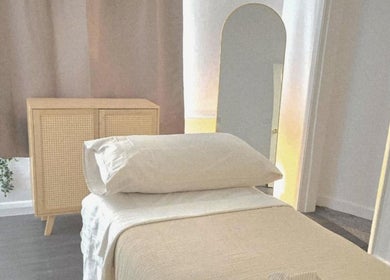 Calming treatment room at Santara Thai Wellness in Salford, England, GB, featuring a cozy massage table.