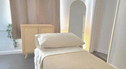Calming treatment room at Santara Thai Wellness in Salford, England, GB, featuring a cozy massage table.