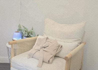 A calming chair setup at Santara Thai Wellness, Salford, England, GB, featuring a soft robe and ambient lighting.