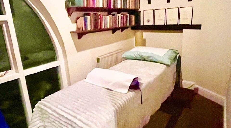 Cozy therapy room at Holistic Healing, London, England, GB with a comfortable bed and calming decor.
