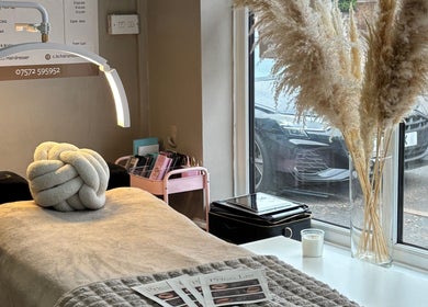 Cozy treatment room at Beauty Bliss, Hartlebury, England, GB, featuring plush decor and soft lighting.