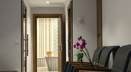 Elegant waiting area at Let's Relax My Spa, İstanbul, TR, featuring comfortable seating and vibrant orchids.