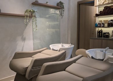 Modern salon wash area at Mystt by Sophia Ladies Salon L.L.C Dubai, AE, featuring plush reclining seats.