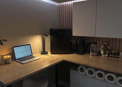 Silk Touch Tattoos cozy workspace in Colchester, England, GB featuring a laptop and decor.