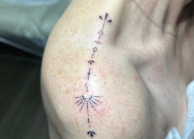 Delicate celestial tattoo on shoulder at Silk Touch Tattoos, Colchester, England, GB.