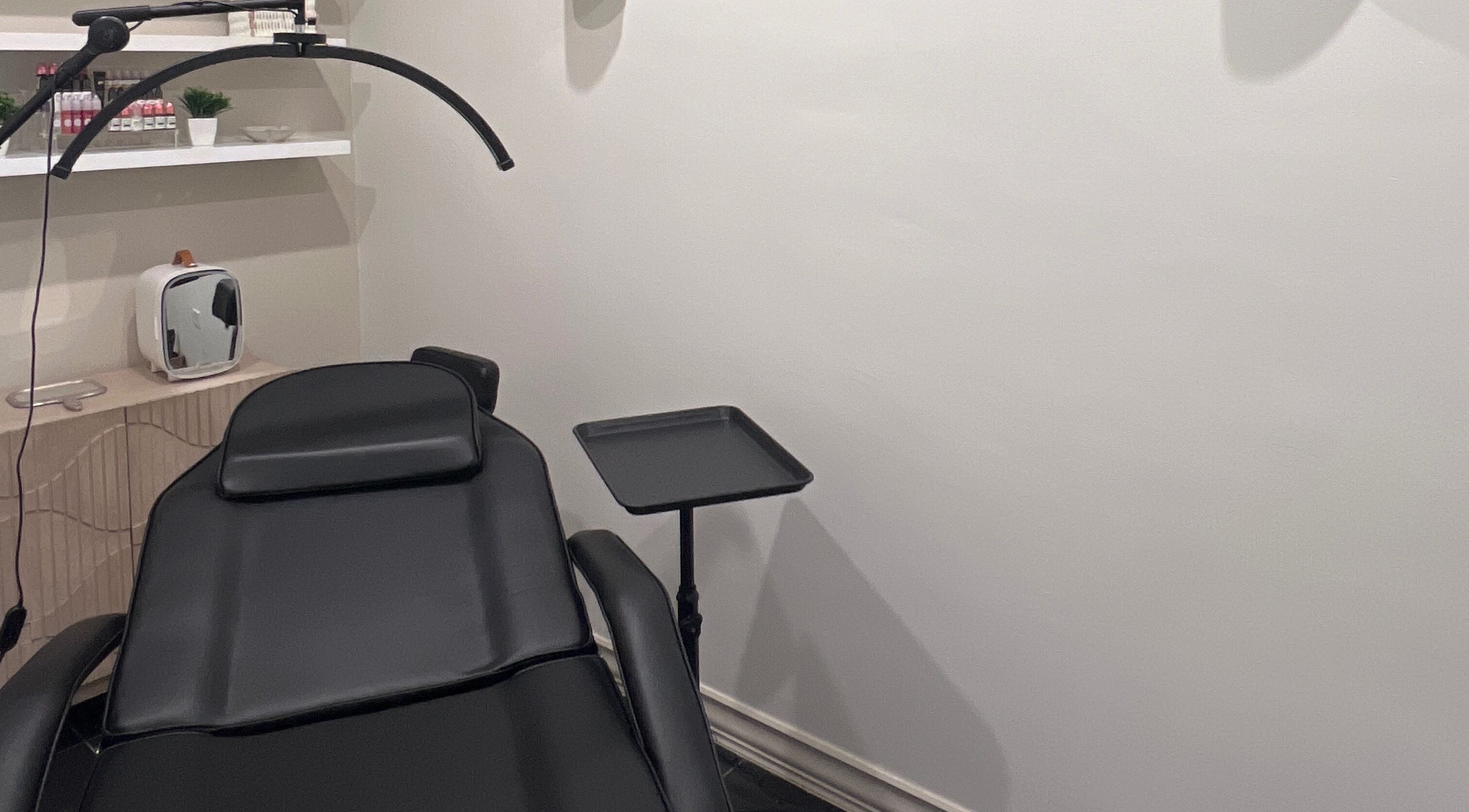 Treatment room at Sora, Cole Bay, SX with black reclining chair and cozy aesthetic.
