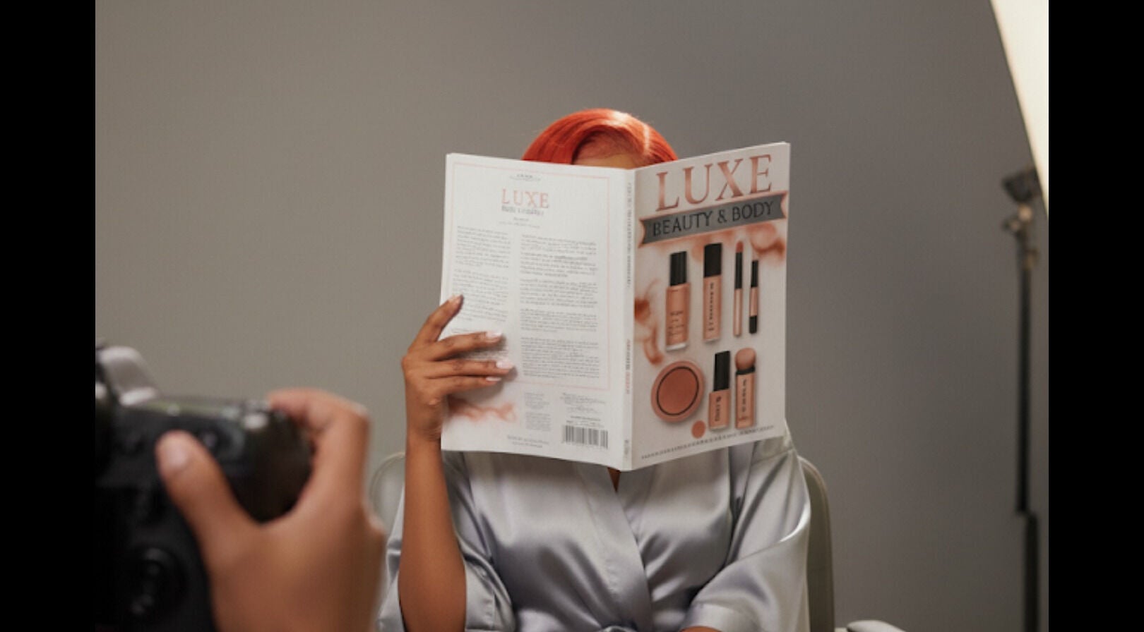 Person reading Luxe Beauty & Body magazine at Woodlawn, Maryland, US during a photoshoot.