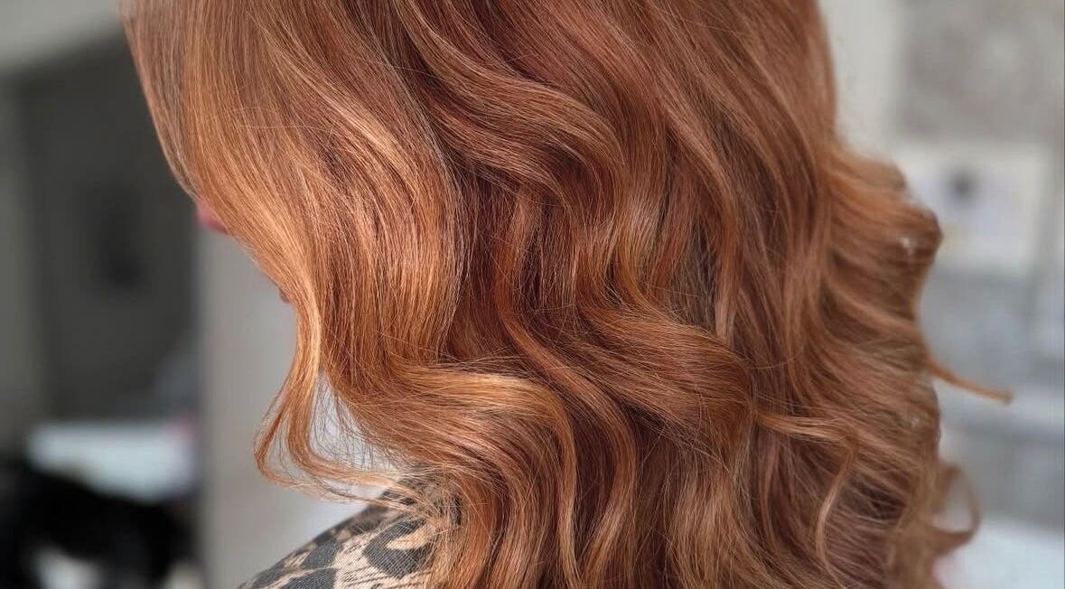Lustrous copper waves styled at Nova - Hair, Coulsdon, England, GB for a radiant look.