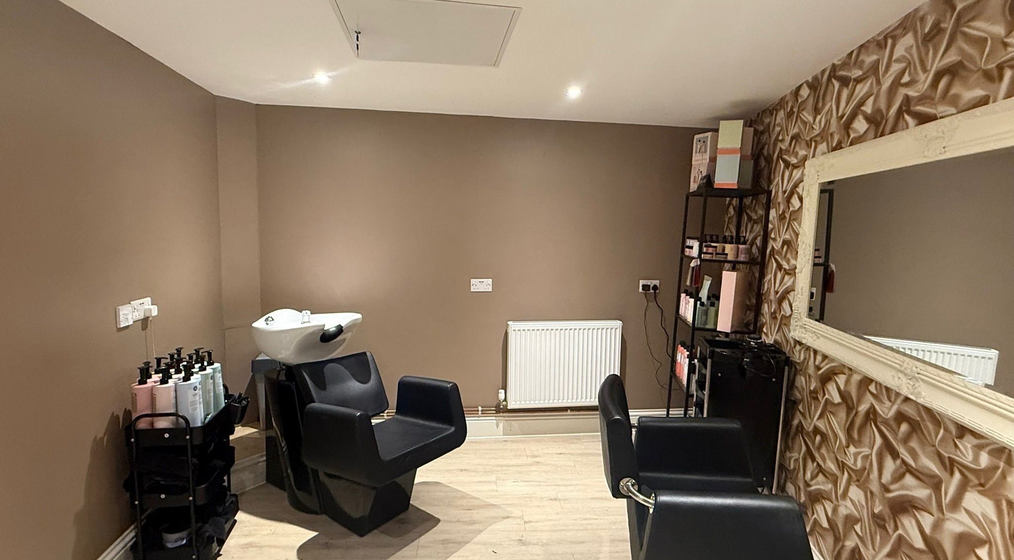 Elegant salon station at Nova - Hair, Coulsdon, England, GB showcasing sophisticated decor and seating.