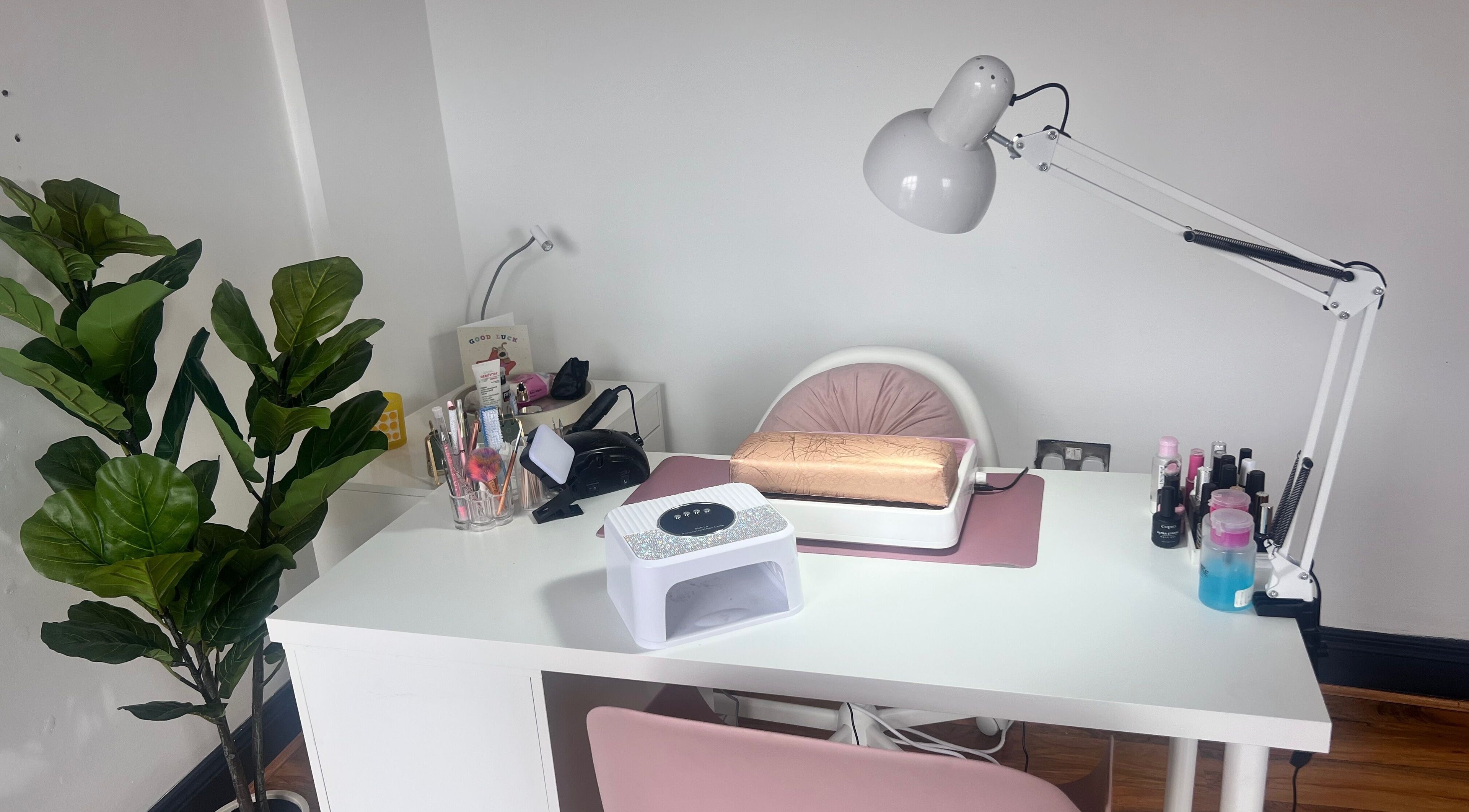 Manicure station at Glow By Diana in Belfast, Northern Ireland, GB, with greenery and beauty tools.